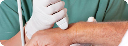 A doctor uses an ultrasound wand to diagnose a patient's wrist problem